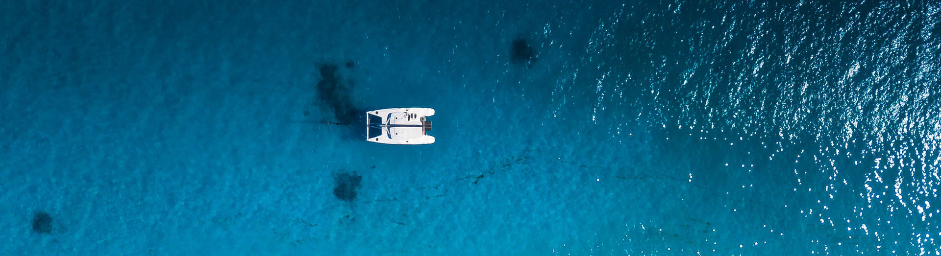 catamaran anchored in blue water